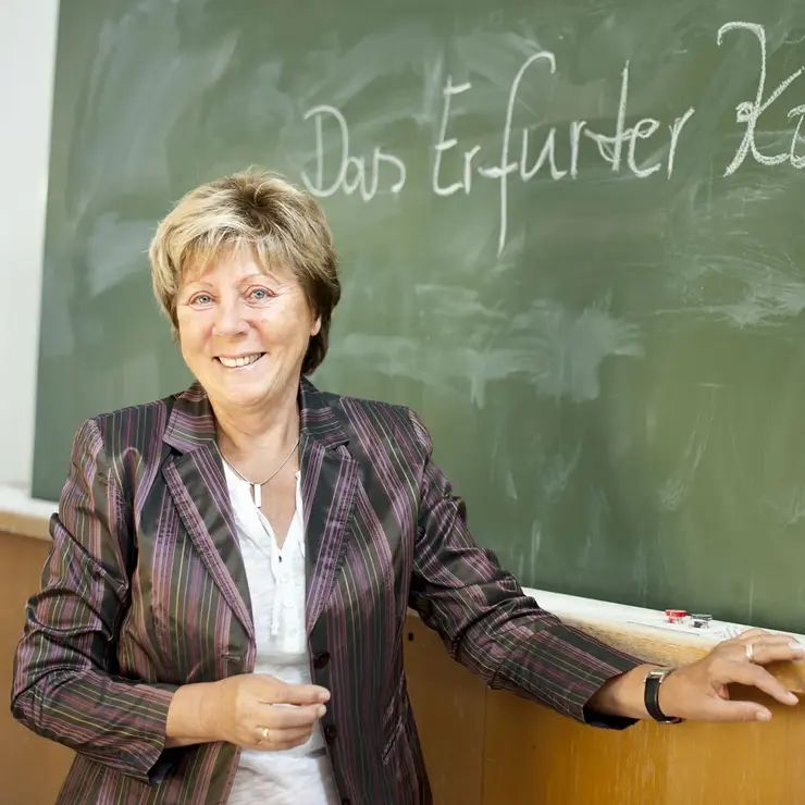 Studentin des Erfurter Kollegs (Seniorenstudium) vor einer Tafel