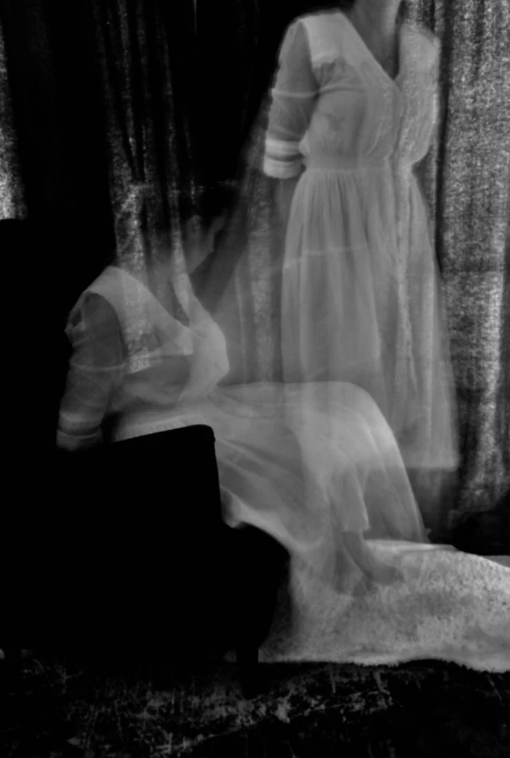 Black and white photograph of a woman looking like a ghost