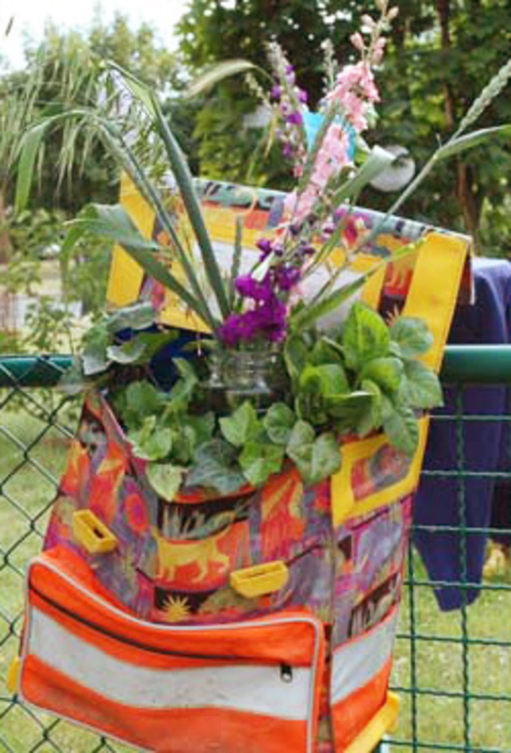 planted satchel on the garden fence