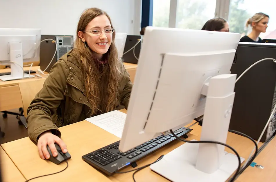Eine Studentin sitzt an einem Rechner-Arbeitsplatz an der Universität Erfurt