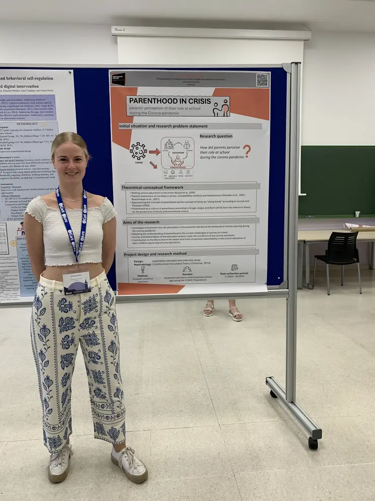 Alicia Göthe steht vor Ihrem Poster aus der Fachtagung des JURE-Netzwerks der European Association for Research on Learning and Instruction (EARLI) in Sevilla