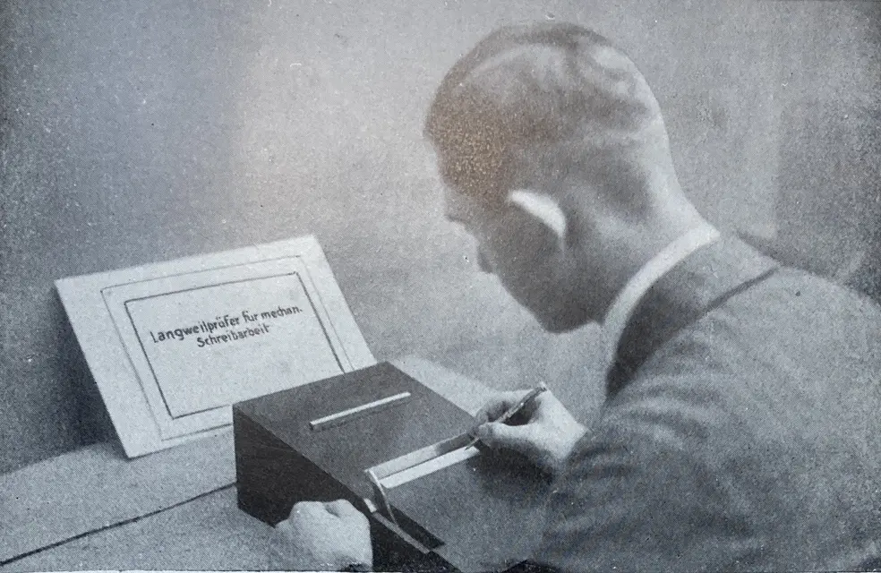 A man looking at a Titlecard with a device in front of him